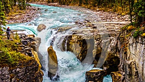 The turbulent turquoise water of the Sunwapta River as it tumbles down Sunwapta Falls in Jasper National Park