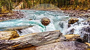 The turbulent turquoise water of the Sunwapta River as it tumbles down Sunwapta Falls in Jasper National Park