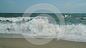 Turbulent water on a sandy coastline