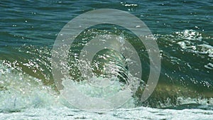 Turbulent water on a sandy coastline