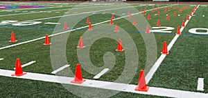 Turf field set up with orange cones for agility exercises