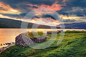 Turf-top houses on the coast of Sorvagsvatn lake, Vagar island. Unbelievable sunset view of Faroe Islands, Denmark, Europe. Travel