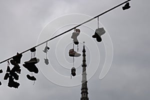 TURIN, ITALY - 25 May 2019: Shoes on the string with Mole Antonelliana on the background, Turin, Piedmont, Italy - Image