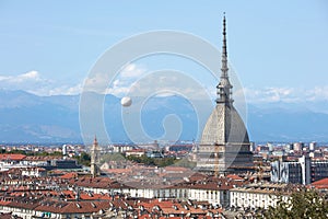 Turin skyline view, Mole Antonelliana tower and hot air balloon in a sunny day in Italy