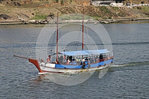 turistic boat with plenty turist inside in vitoria harbour