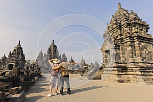 Turistic couple standing in front of ancient sewu temple in indonesia