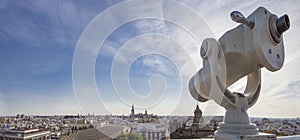 Turistic telescope pointing to old town landmarks, Seville, Spain