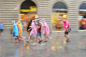 Turists in Florence Italy taking shelter under the heavy rain on a summer day
