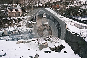 Turkey, Artvin, cifte kopru, Stone made bridge at winter, snow covers the bridge at winter.