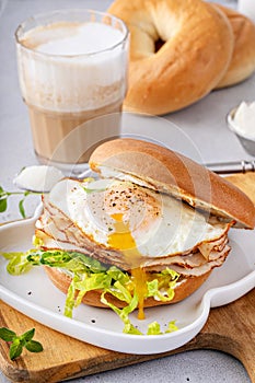 Turkey bagel breakfast sandwich with lettuce and fried egg