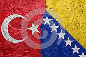 Turkey and Bosnia and Herzegovina - Cracked concrete wall painted with a Turkish flag on the left and a Bosnia flag on the right