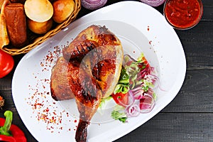 Turkey or chicken on wooden table and ingredients. Christmas or Thanksgivin table