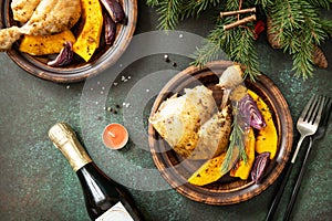 Turkey christmas dinner. Baked turkey or chicken with pumpkin and red onion garnish on the festive table. Top view flat lay