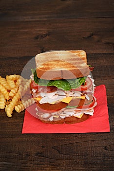 Turkey club sandwich on red napkin