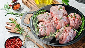 Turkey cutlets with spices and rosemary, ready to cook. Barbecue. On a black concrete background.