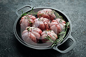 Turkey cutlets with spices and rosemary, ready to cook. Barbecue. On a black concrete background.