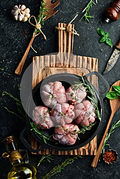 Turkey cutlets wrapped in turkey fillet, ready to cook. Barbecue. On a black concrete background.