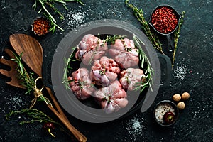 Turkey cutlets wrapped in turkey fillet, ready to cook. Barbecue. On a black concrete background.