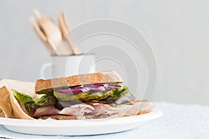 turkey deli sandwich on a plate with vegetables