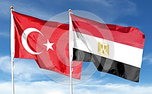 Turkey flag and Egypt flag on cloudy sky. waving in the sky photo