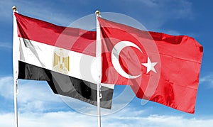 Turkey flag and Egypt flag on cloudy sky photo