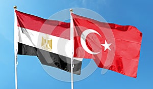 Turkey flag and Egypt flag on cloudy sky. waving in the sky photo