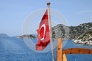 Turkey flag at the stern of a pleasure . View of Mediterranean coast