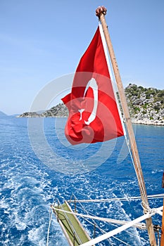 Turkey flag at the stern of a pleasure yacht. View of Mediterranean coast