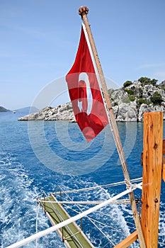 Turkey flag at the stern of a pleasure yacht. View of Mediterranean coast