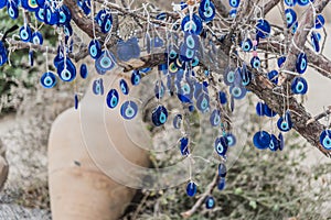 Hanging blue evil eyes Nazar Boncugu on the tree photo