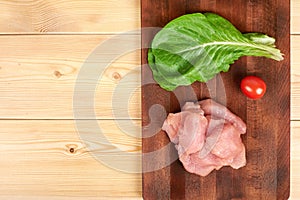 Turkey raw breast pieces on a cutting board wooden background, Copyspace for your text