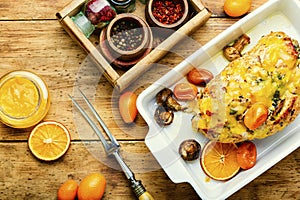 Turkey roll with kumquat and orange,wooden table