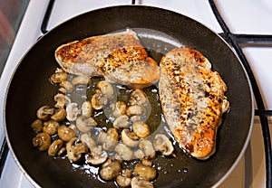 Turkey steak with mushrooms cooking pan fried.