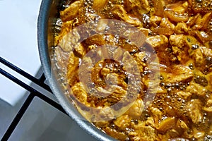 Turkey stew in the tomato sauce inside a frying pan, beign cooked