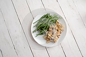 Turkey Stroganoff on white wood table with green beans