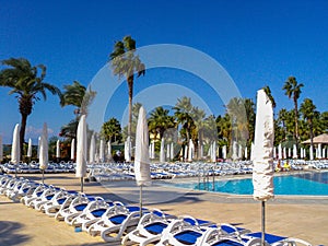 Turkey Swimming pool with the some beach lounges at the luxury tropical resort.