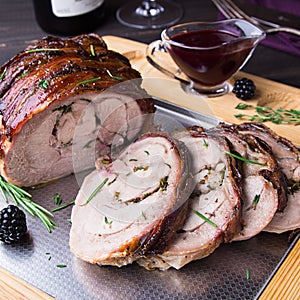 Turkey Thigh Roll Stuffed Rosemary, Thyme, Parsley, Butter and Bacon on the top with Spicy Blackberry Sauce