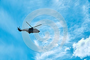 Turkish air force Sikorsky helicopter flying against blue sky and clouds background