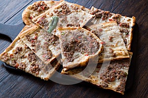 Turkish and Arabic Traditional Ramadan Bread Sliced Etli Ekmek Kebab with Minced Meat Pide or Lahmacun Kebap serving on wood by