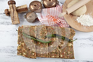 Turkish and Arabic Traditional Sliced Etli Ekmek Pide or Lahmacun serving on wood background