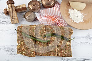 Turkish and Arabic Traditional Sliced Etli Ekmek Pide or Lahmacun serving on wood background