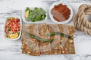 Turkish and Arabic Traditional Sliced Etli Ekmek Pide or Lahmacun serving on wood background