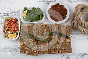 Turkish and Arabic Traditional Sliced Etli Ekmek Pide or Lahmacun serving on wood background