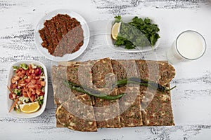 Turkish and Arabic Traditional Sliced Etli Ekmek Pide or Lahmacun serving on wood background