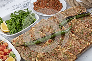 Turkish and Arabic Traditional Sliced Etli Ekmek Pide or Lahmacun serving on wood background