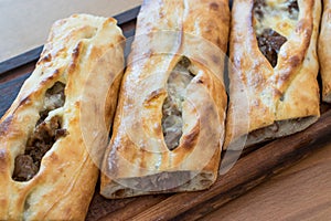 Turkish Bafra Pide with Minced Meat Kavurma Salad and Pickles.