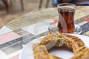 Turkish bagel with a glass of tea in the cafe, close up photo