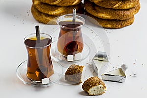 Turkish Bagel,`Simit` and tea on white surface with creamy cheese