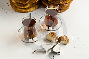 Turkish Bagel,`Simit` and tea on white surface with creamy cheese