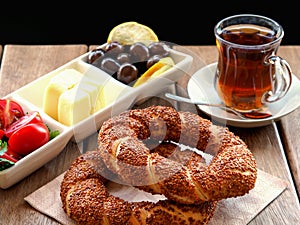 Turkish bagel on wooden table, tea and breakfast plate.